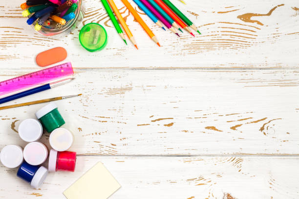 istock School supplies on a white wooden background with an empty space for inscriptions. 827380508