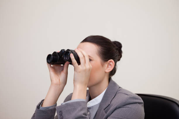 istock Businesswoman having a look through binoculars 827383360