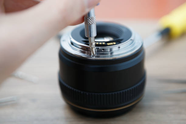 istock Broken DSLR lens repair service in workshop 827389986