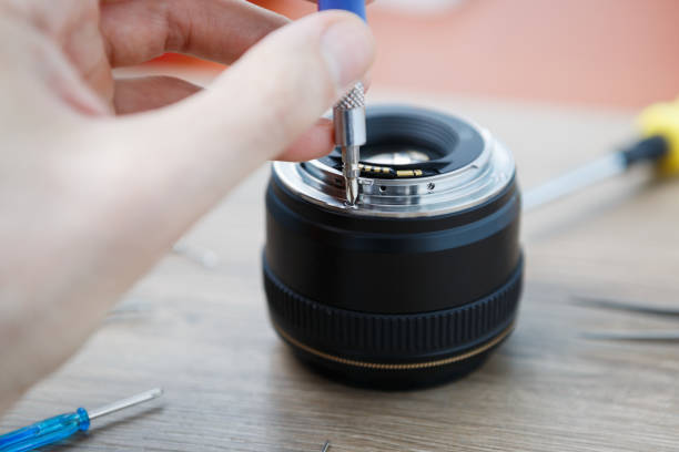 istock Broken DSLR lens repair service in workshop 827390064
