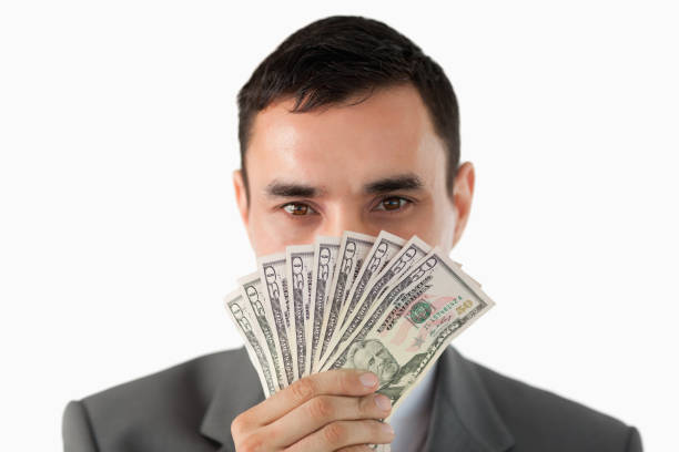 istock Businessman smelling on banknotes 827390416
