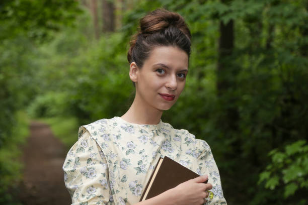 istock Girl in the woods with a book 827390504