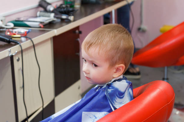 istock Cute little boy at the barbershop 827394774