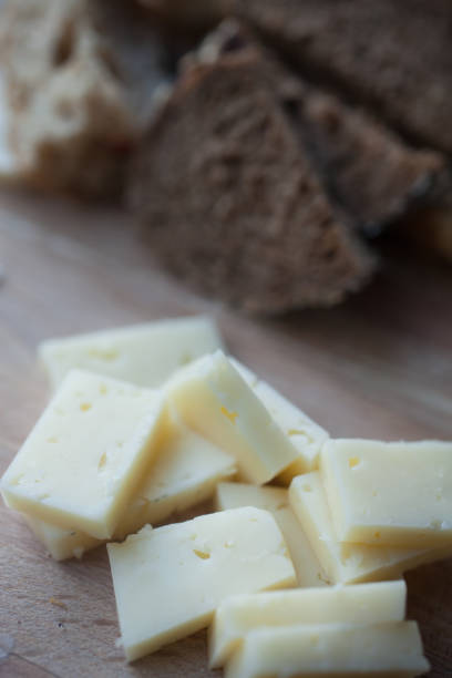 istock Sliced bread and cheese lay on a wooden platter 827394806