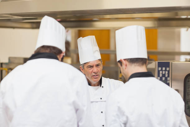 istock Angry head chef scolding employees 827397376