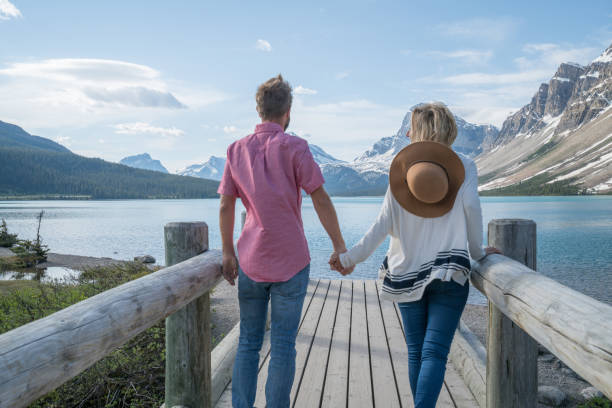istock Cheerful couple on log bridge admiring landscape 827400530
