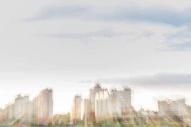 Background urban concept, abstract blurred city skyscraper and clouds.