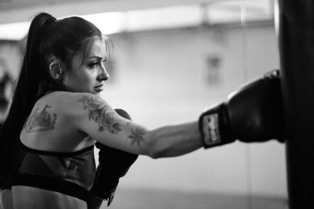 istock Young woman at her boxing training 827407378