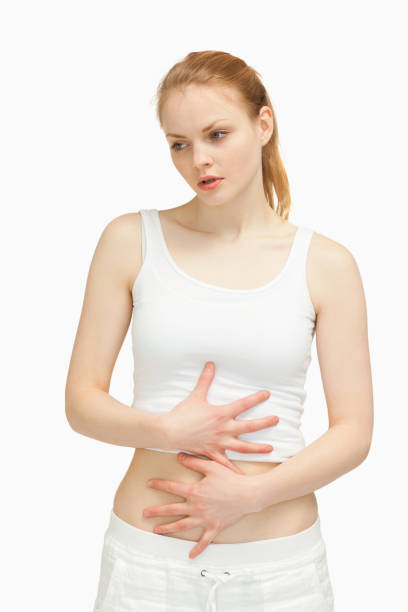 istock Serious woman placing her hands on her stomach 827407528