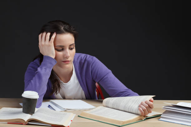 istock attractive female student in classroom with books 827410458