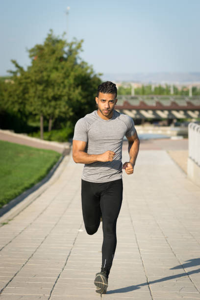 istock Young black male running towards the camera 827413984