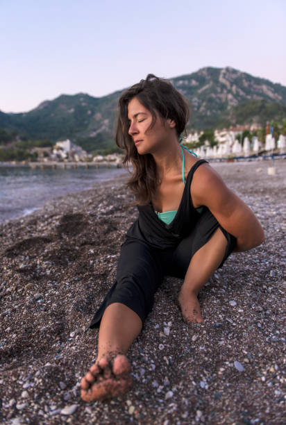 istock Young woman doing yoga exercise 827419182