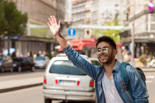 istock Young Man Hailing a Taxi . 827422434