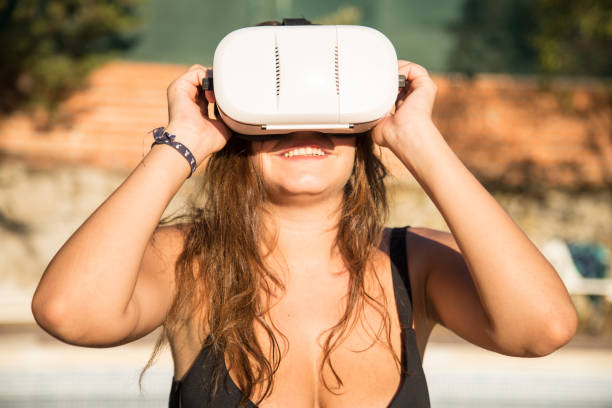 istock Woman with VR headset on poolside 827422658