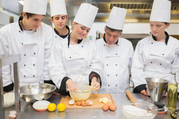 istock Pastry chef showing students how to prepare dough 827422746