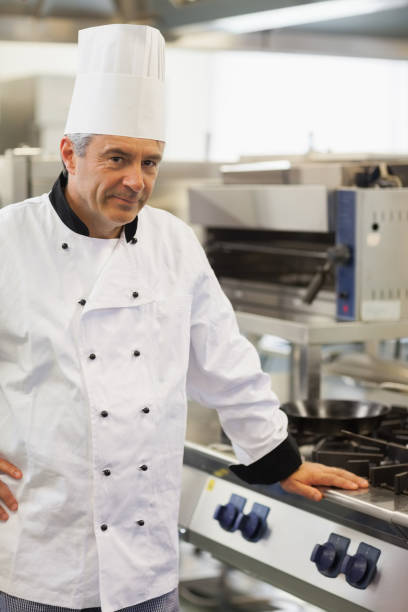 istock Chef leaning against the stove 827422910