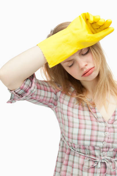 istock Tired woman wearing cleaning cloves 827425962