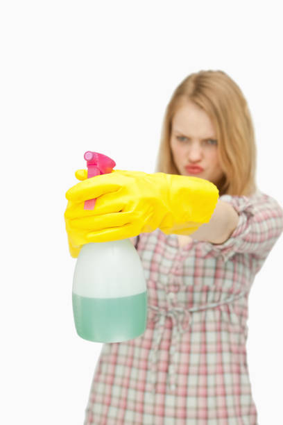 istock Young woman holding a spray bottle 827425986