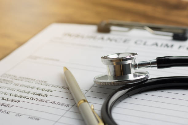 health insurance claim form with stethoscope on wood table selective focus stock photo