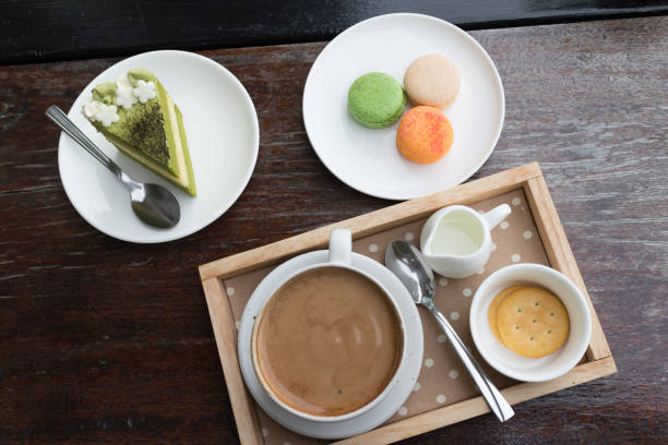 istock hot coffee breakfast set with green tea cake and fresh macaron in cafe 827429812