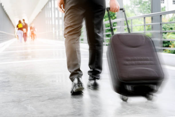 istock Businessman holding trolley bag going up on travel 827432542