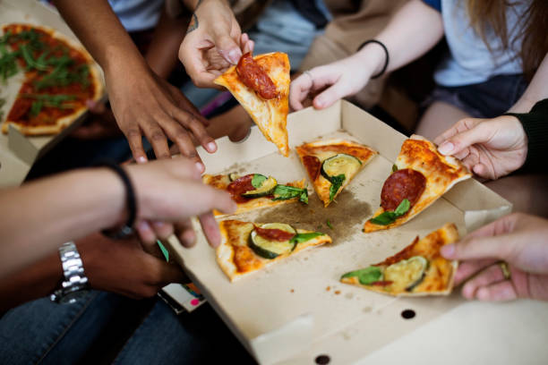 istock Pizza Sharing Togetherness Friendship Community Concept 827433144