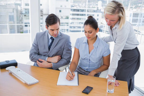 istock Businesswoman showing colleagues something on her notepad 827433930