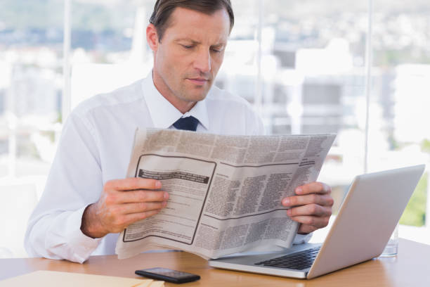 istock Businessman reading a newspaper 827434740