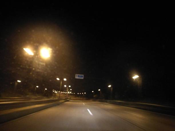 istock Travel at night on deserted road 827438164