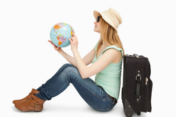 istock Woman sitting while holding a world globe 827442188