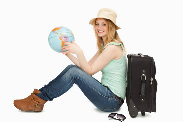 istock Woman smiling while holding a world globe 827442194