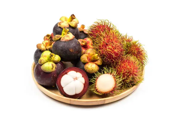 Fresh Rambutan and Mangosteen from Rayong Thailand on wooden plate isolated on white background, Sweet delicious fruit