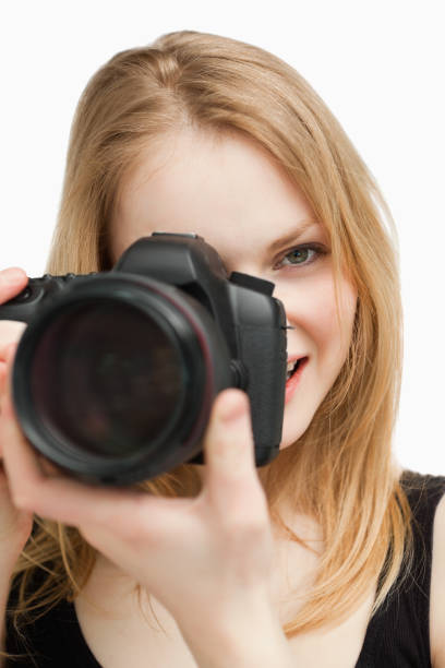 istock Blonde woman aiming with a camera 827442250