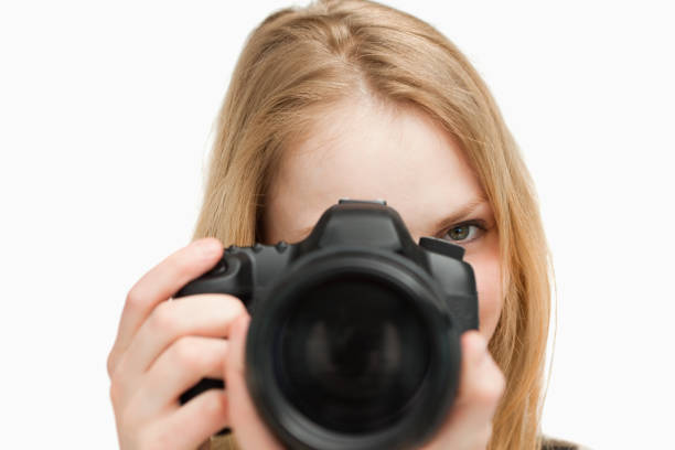 istock Young woman holding a camera 827442258