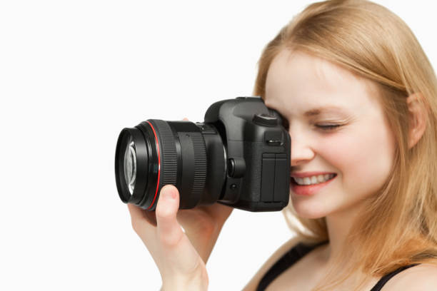 istock Smiling woman holding a camera 827442296