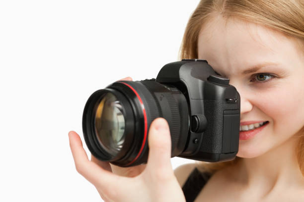 istock Cheerful woman shooting with a camera 827442300