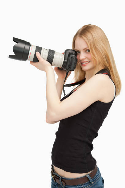 istock Joyful woman holding a SLR camera 827444164