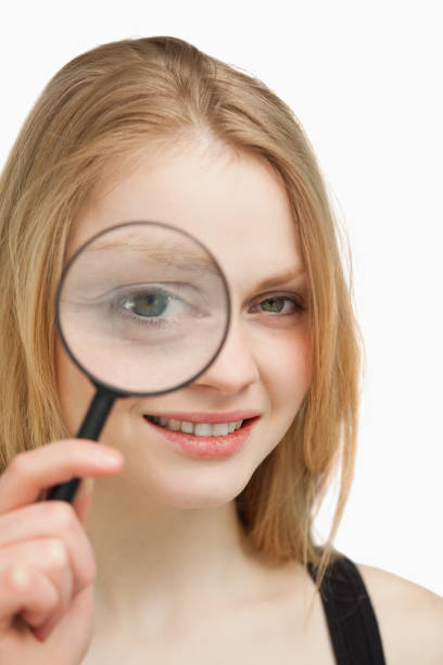 istock Close up of a woman using a magnifying glass 827444558