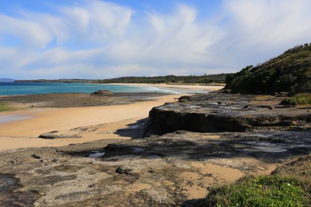 Soft pastel sky at Racecourse Beach in Ulladulla NSW Beautiful clouds at Racecourse Beach Beach at Ulladulla on the south coast of New South Wales in Australia shoalhaven stock pictures, royalty-free photos & images
