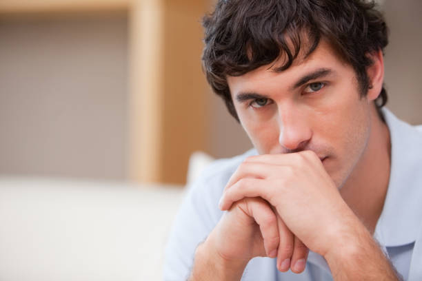 istock Man in the living room in thoughts 827449066