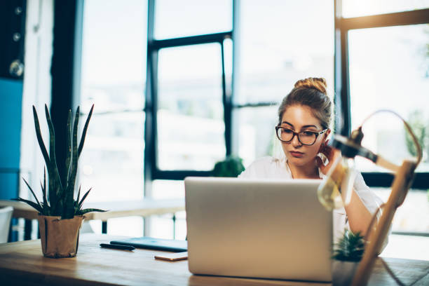 istock Young beautiful woman working at the office with laptop 827449548