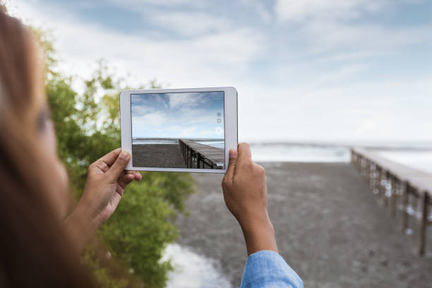 istock woman use digital tablet taking landscape photo 827453154