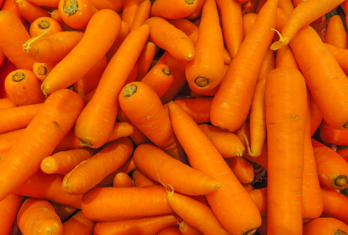 Background of fresh small carrot on the market stall