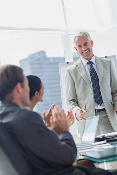 istock Colleagues applauding the manager during a meeting 827454508