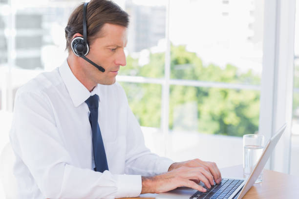 istock Serious businessman wearing a headset 827454682