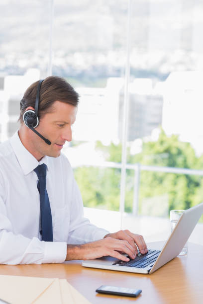 istock Businessman wearing a headset 827454712