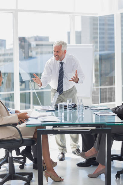 istock Furious boss gesturing in front of employees 827456886