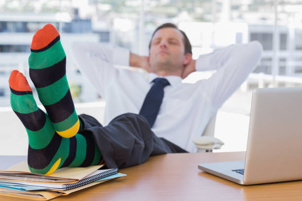 istock Businessman sleeping with feet on his desk 827456916