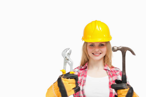 istock Woman smiling while wearing a safety helmet 827457558