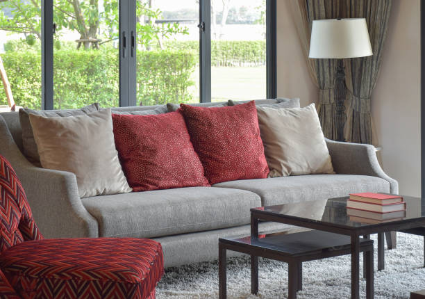 istock modern living room design with red pillows on sofa and decorative table lamp 827457574
